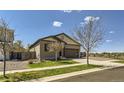 Well-maintained single-story home with a two-car garage and a neatly landscaped front yard at 17720 Weymouth Ave, Parker, CO 80134