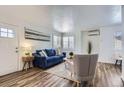 Bright living room showcases wood floors, neutral decor, and a cozy seating arrangement at 2060 W Iliff Ave, Englewood, CO 80110