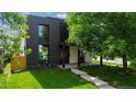 Contemporary home featuring dark brick, modern windows, and a well-manicured lawn at 1601 S Columbine St, Denver, CO 80210