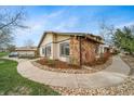 Exterior of home shows attractive stone accents and a well-manicured yard at 16086 E Ithaca Pl # D, Aurora, CO 80013