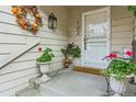 Inviting front porch with a welcome mat, seasonal wreath, and planters adding charm and curb appeal at 4505 S Yosemite St # 102, Denver, CO 80237