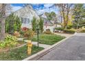Charming home with lush landscaping, mature trees, and a well-maintained lawn at 4505 S Yosemite St # 102, Denver, CO 80237