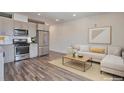 Open concept living area with modern kitchen, stainless steel appliances, and comfortable seating at 2374 S University Blvd # 503, Denver, CO 80210