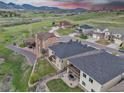 Aerial view of houses in a residential area with green grass and mountain views at 9754 W Ontario Pl, Littleton, CO 80128