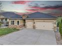 Stucco home with stone accents, two-car garage, and well-maintained landscaping at 9754 W Ontario Pl, Littleton, CO 80128