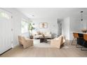 Bright living room with wood floors, neutral tones, and comfortable seating arrangement at 3065 S Eudora St, Denver, CO 80222