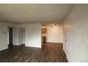 Open-concept living area with wood-look flooring and updated lighting at 10211 Ura Ln # 9-308, Thornton, CO 80260