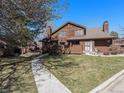 Inviting two-story house with a well-manicured lawn and a charming walkway leading to the entrance at 9365 W 80Th Pl # C, Arvada, CO 80005