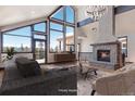 Inviting living room with soaring windows, stone fireplace, and comfortable seating at 160 N Fuller Placer Rd, Breckenridge, CO 80424