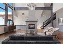 Cozy living room featuring a stone fireplace, hardwood floors, and stylish decor at 160 N Fuller Placer Rd, Breckenridge, CO 80424