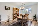 Cozy dining room featuring a round wooden table, vintage chairs, and a decorative bookshelf at 3803 Dyanna Dr, Thornton, CO 80241
