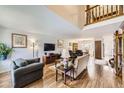 Spacious living room with hardwood floors, comfortable seating, and a warm, inviting atmosphere at 3803 Dyanna Dr, Thornton, CO 80241