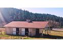 This barn boasts multiple stalls with sliding doors, enhancing its functionality for livestock and horses at 3841 Myers Gulch Rd, Kittredge, CO 80457