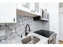 A close up of the kitchen sink, backsplash, and stainless steel oven at 3035 Oneal Pkwy # 20V, Boulder, CO 80301
