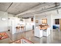 Modern open concept kitchen with concrete floors, sleek white cabinetry, and stainless steel appliances at 1610 Little Raven St # 302, Denver, CO 80202