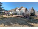 A spacious backyard deck area provides ample seating, perfect for outdoor relaxation and entertaining with views of the lawn at 8338 E 148Th Way, Thornton, CO 80602