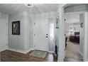 Bright foyer featuring wood floors, a decorative rug, and an interior door with light coming in from the next room at 8338 E 148Th Way, Thornton, CO 80602