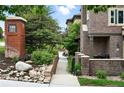 Attractive two-story townhome featuring brick exterior, manicured landscaping, and welcoming front entrance at 681 W Burgundy St # A, Highlands Ranch, CO 80129