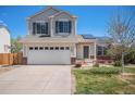 Charming two-story home with a well-manicured lawn, solar panels, and an attached two-car garage at 3543 S Ceylon Way, Aurora, CO 80013