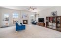 Bright living room featuring a cozy fireplace, plush furniture, and ample natural light at 3543 S Ceylon Way, Aurora, CO 80013