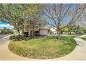 Townhouse with well-maintained lawn and mature trees, with a sidewalk at 1311 S Kingston St, Aurora, CO 80012