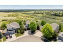 Picturesque aerial view of a suburban home nestled amidst lush greenery and rolling hills, offering serene privacy at 7852 Solstice Way, Castle Rock, CO 80108
