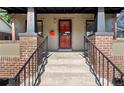 Welcoming entryway with a decorative security door, bright red mailbox, and brick accents at 3529 N Garfield St, Denver, CO 80205