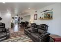 The living room features a leather reclining sofa set with outdoor accessories and light at 3550 S Harlan St # 249, Denver, CO 80235