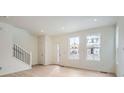 Bright entryway with light hardwood floors, staircase, and an abundance of natural light at 14556 W 91St Ave # D, Arvada, CO 80005