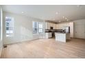 Open concept kitchen with white cabinets, stainless steel appliances, and island at 14556 W 91St Ave # D, Arvada, CO 80005