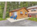 Cozy log cabin offers outdoor seating and a tranquil setting amidst the forest at 8758 S Murphy Gulch Rd, Littleton, CO 80127