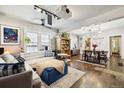 Open living and dining area with hardwood floors and unique light fixture at 2469 S Broadway, Denver, CO 80210