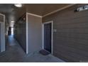 Neutral-toned hallway with outdoor access leading to unit 107 at 1425 Blue Sky Cir # 15-107, Erie, CO 80516