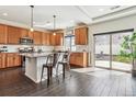 Modern kitchen with granite countertops, a large island and stainless steel appliances at 5352 Truckee St, Denver, CO 80249