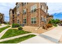 Attractive condo exterior with stone accents, multiple windows, and well-maintained landscaping at 9185 Wilde Ln # 101, Parker, CO 80134