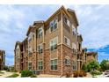 Attractive condo exterior with stone accents, multiple windows, and well-maintained landscaping at 9185 Wilde Ln # 101, Parker, CO 80134