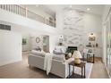 Open-concept living room features high ceilings, modern fireplace, and a view from the second story at 5944 E Irwin Pl, Centennial, CO 80112