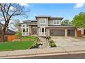 Contemporary home boasts a stylish brick and siding facade, complemented by a beautifully landscaped front yard at 6656 S Oak Cir, Littleton, CO 80127