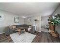 Cozy living room with gray sofa, stylish coffee table, and wood flooring at 855 N Pennsylvania # 207, Denver, CO 80218