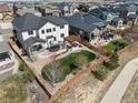 Aerial view of a home with a backyard that includes a pergola, trampoline, lush landscaping, and fencing at 228 Horizon Ave, Erie, CO 80516