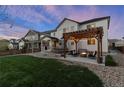 An outdoor haven featuring a pergola, inviting seating, and a cozy fire pit for relaxation and enjoyment at 228 Horizon Ave, Erie, CO 80516