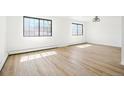 Light-filled bedroom with wood-look floors, offering a peaceful and spacious retreat at 2633 Mather St, Brighton, CO 80601
