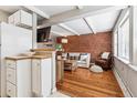 Inviting living room featuring exposed brick wall, wood floors, and comfortable seating with lots of natural light at 160 Jackson St # 5, Denver, CO 80206