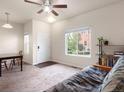 Bright living room with large windows, neutral carpet, and comfortable furnishings at 1456 Sepia Ave, Longmont, CO 80501