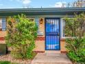 A close up of the front door with a blue security door and light fixture above it at 4201 Shoshone St, Denver, CO 80211