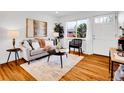 Cozy living space with hardwood floors, a gray couch, and natural light from a nearby window at 4201 Shoshone St, Denver, CO 80211