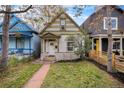 Charming home with unique detailing and a cozy front porch, surrounded by a well-maintained lawn at 1020 Kalamath St, Denver, CO 80204