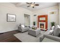The living room showcases a fireplace, a gray sofa and chairs, and dark hardwood floors at 1020 Kalamath St, Denver, CO 80204
