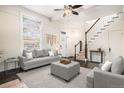 The living room features a neutral rug, gray furniture, a staircase and great natural light at 1020 Kalamath St, Denver, CO 80204