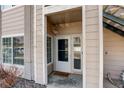 Exterior entryway featuring a storm door, neutral siding, and a cozy welcome mat at 1016 Opal St # 102, Broomfield, CO 80020
